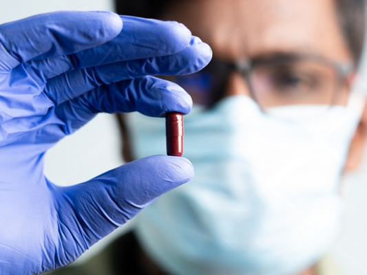 Doctor reviewing clinical trial data on herbal supplements for erectile function