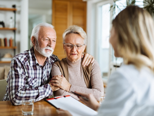 Senior couple discussing erectile-dysfunction treatment options with a healthcare professional.