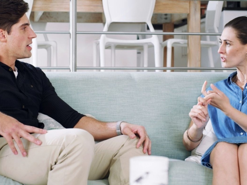 Couple having a calm evening conversation on a sofa representing open communication about male sexual health