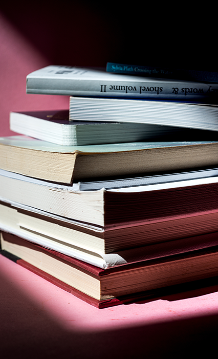 A close up of a stack of books used for Erectimus research into Erectile Dysfunction